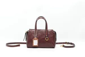 Detailed view of the vintage brown genuine leather top-handle crossbody bag with hardware.