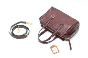 Classic vintage brown leather Boston handbag with detachable strap and elegant retro design.