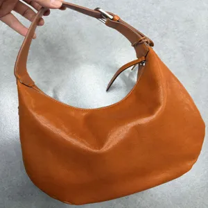 Brown genuine leather hobo shoulder bag for women, elegant crescent design with adjustable strap.