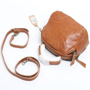 Brown genuine leather shell bag with detachable strap and top handle for women daily use.