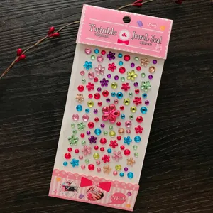 High-detail macro of 3D colorful crystal gem stickers with flower and round shapes