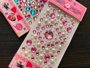 Close-up of pink and white pearl 3D gem stickers for DIY crafts and decoration