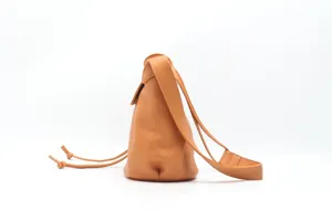 Orange leather bucket shoulder bag detail, stylish drawstring design, premium commuting bag.