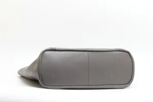 Bottom detail view of grey genuine leather tote bag showing durable stitching and quality leather texture.