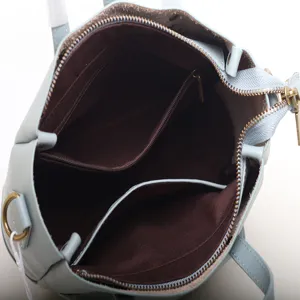 Light blue genuine leather women crossbody handbag with multi-compartment interior.