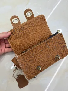 Vintage embossed genuine cowhide leather crossbody bag with chic floral pattern and metal lock.