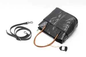 Detailed view of retro leather bucket bag showing genuine cowhide texture and handle.