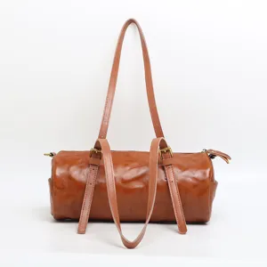 Retro vegetable-tanned leather cylindrical shoulder bag for women, stylish vintage barrel pillow bag.