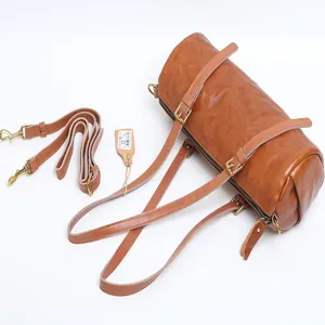 Vintage brown leather cylinder shoulder bag for women, stylish crossbody pillow bag main view.