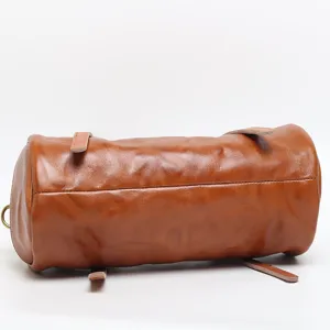 Retro brown leather cylindrical shoulder bag for women, stylish versatile barrel handbag.