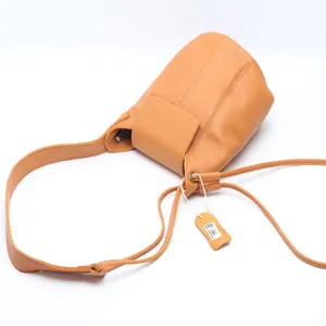Genuine leather bucket bag for women, casual shoulder bag with a stylish strap.