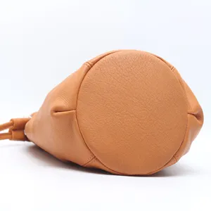 Genuine leather bucket bag for women, stylish brown shoulder bag showing bottom detail.