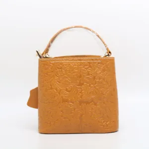 Vintage embossed cowhide leather bucket bag, classic floral pattern casual handbag for women.