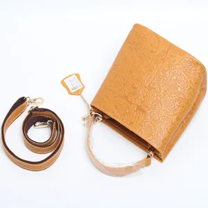 Vintage embossed cowhide leather bucket bag featuring a detachable shoulder strap for women.