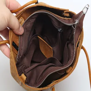 Genuine leather bucket bag with large capacity, multi-pocket interior design for daily women use.