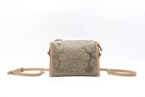 Detail view of vintage genuine leather embossed crossbody bag showcasing fine craftsmanship.