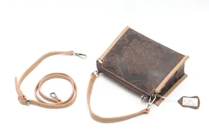Detailed view of vintage embossed genuine cowhide leather crossbody shoulder bag with strap.