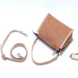 Vintage embossed genuine cowhide leather shoulder crossbody bag for women with strap tag.