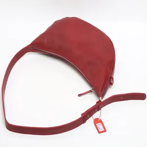 Stylish red vegetable-tanned crystal leather crescent crossbody shoulder bag for women.