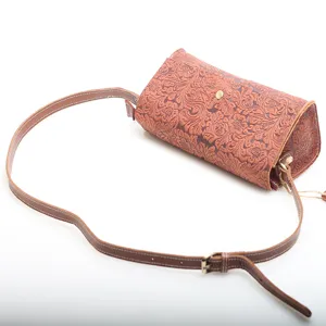 Genuine cowhide leather shoulder crossbody bag with vintage embossed floral design and strap.