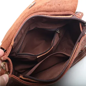 Brown genuine leather shoulder bag with zipper compartments, retro embossed design for women.