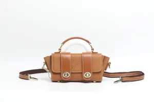 Vintage brown leather embossed handbag with top handle and shoulder strap for women detail.