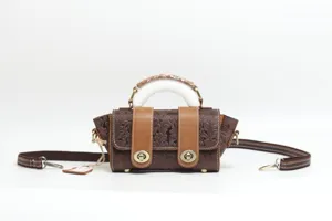 Vintage embossed genuine leather handbag featuring chic top handle and adjustable strap.
