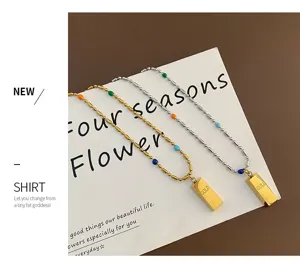 Detail shot of titanium steel gold bar beaded necklace, showcasing delicate colorful bead design.