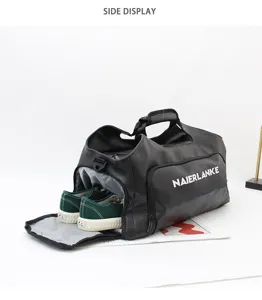 Detail view of black travel duffel bag featuring a convenient side shoe compartment.