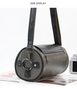 Men cylindrical shoulder bag side detail, stylish leather crossbody bag with metal rings.