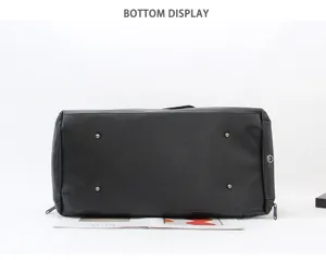 Black large capacity travel duffel bag bottom view showing metal feet and shoe compartment details