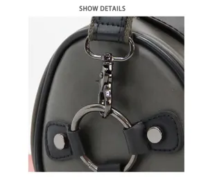 Men cylindrical bag detail shot showing metal hardware strap ring and dark grey leather loop.