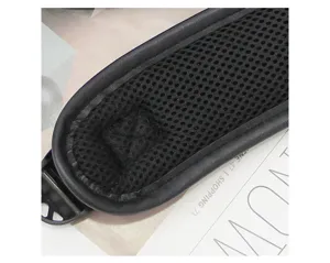 Men's backpack shoulder strap detail, breathable black mesh fabric with durable leather trim.
