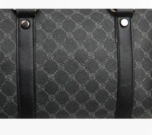 Close-up detail of luxury men travel duffel bag showing exquisite stitching and textured leather.