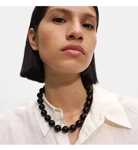 Chunky black statement bead necklace for women, stylish acrylic round beaded jewelry item.