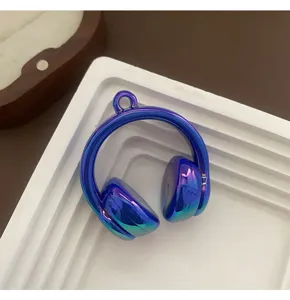 Detailed close-up view of an electroplated iridescent blue headphone charm for DIY.