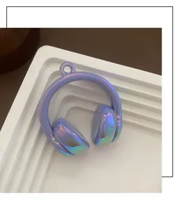 Detailed shot of iridescent purple acrylic headphone pendant, ideal for DIY phone charms.