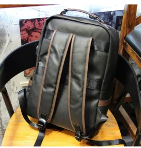 Men's casual black backpack with brown straps, stylish daily bookbag for student use.
