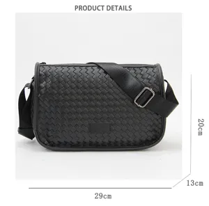 Detailed view of black woven messenger bag showcasing intrecciato texture and hardware.