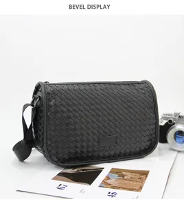 Detail view of the black woven crossbody bag showcasing its premium texture and craftsmanship.