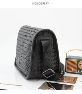 Side view detail of black woven leather crossbody bag, featuring classic intrecciato texture design.