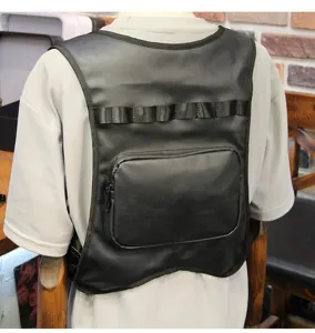 Close-up detail of black tactical vest backpack, featuring multi-pocket wearable chest design.