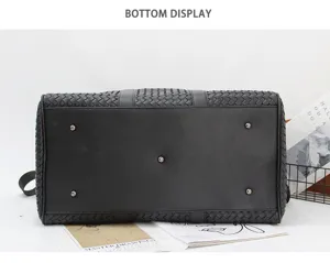 Black woven leather travel bag bottom detail, large capacity business luggage duffel.