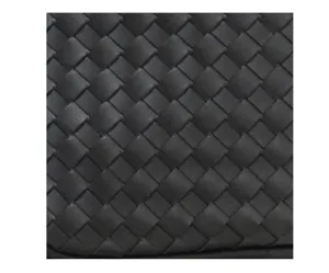 Close-up detail of black woven leather texture, showcasing fine handcrafted grid craftsmanship.