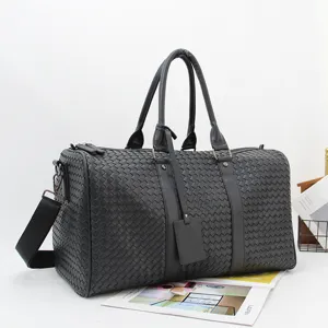 Men's black woven leather travel duffel bag, large capacity business luggage and shoulder bag.