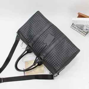Black woven leather duffel bag for men, large capacity travel luggage shoulder bag.