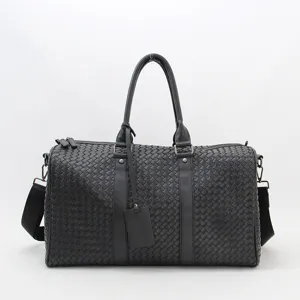 Black woven leather travel duffel bag, large capacity business luggage and shoulder bag.