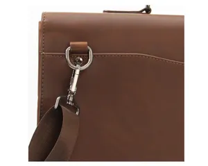 Close-up of vintage brown men's briefcase strap buckle and metal hardware detail craftsmanship.
