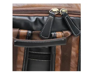 Detailed close-up view of vintage brown and black backpack handle and metal zippers.