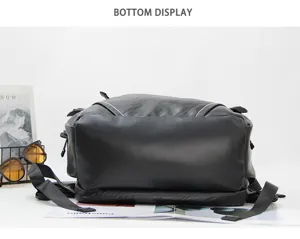 Close-up view of the black leather backpack bottom, showing durable material and fine stitching.